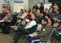 people at an event taking notes